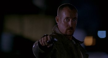 Movie still from “Nothing to Lose” (1997), directed by Steve Oedekerk – A person holding a remote control; Close Up shot, Low angle