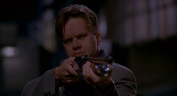 Movie still from “Nothing to Lose” (1997), directed by Steve Oedekerk – A man holding a gun in his hands; Close Up shot, Low angle