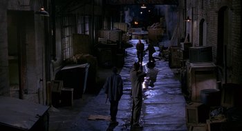 Movie still from “Nothing to Lose” (1997), directed by Steve Oedekerk – A group of people walking down a street at night; Extreme Wide shot, High angle