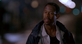 Movie still from “Nothing to Lose” (1997), directed by Steve Oedekerk – A person wearing a jacket; Close Up shot, Over the shoulder angle