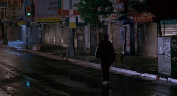 Movie still from “Nothing to Lose” (1997), directed by Steve Oedekerk – A person walking down a street at night; Extreme Wide shot, Low angle