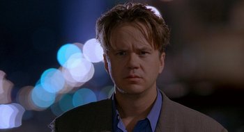 Movie still from “Nothing to Lose” (1997), directed by Steve Oedekerk – A person wearing a suit and tie; Close Up shot, Over the shoulder angle