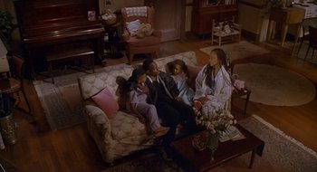 Movie still from “Nothing to Lose” (1997), directed by Steve Oedekerk – A group of people sitting on top of a couch; Wide shot, High angle