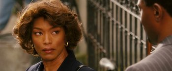 Movie still from “Notorious” (2009), directed by George Tillman Jr. – A woman's face in front of an iron fence; Close Up shot, Over the shoulder angle