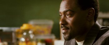 Movie still from “Notorious” (2009), directed by George Tillman Jr. – A man's face in front of a green wall; Close Up shot, Over the shoulder angle