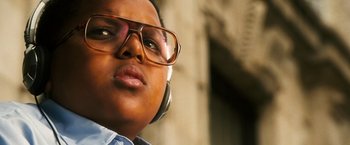 Movie still from “Notorious” (2009), directed by George Tillman Jr. – A person wearing glasses and headphones; Close Up shot, Low angle