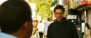 Movie still from “Notorious” (2009), directed by George Tillman Jr. – A man in a black jacket is standing on the street; Close Up shot, Over the shoulder angle