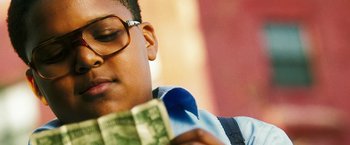 Movie still from “Notorious” (2009), directed by George Tillman Jr. – A man holding a dollar bill in front of his face; Close Up shot, Low angle