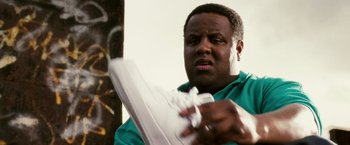 Movie still from “Notorious” (2009), directed by George Tillman Jr. – A man holding a nintendo wii game controller in his hands; Close Up shot, Low angle