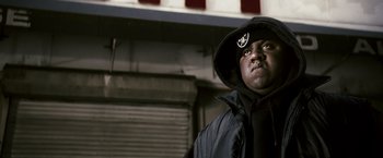 Movie still from “Notorious” (2009), directed by George Tillman Jr. – A man in a black jacket and a black hat; Close Up shot, Low angle