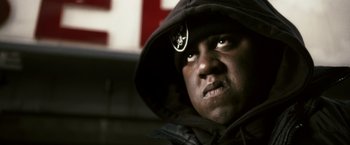 Movie still from “Notorious” (2009), directed by George Tillman Jr. – A person wearing a hooded jacket; Close Up shot, Low angle