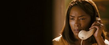 Movie still from “Notorious” (2009), directed by George Tillman Jr. – A person looking sad with her eyes wide open; Close Up shot, Over the shoulder angle