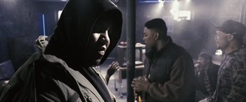 Movie still from “Notorious” (2009), directed by George Tillman Jr. – Two men standing next to each other in a dark room; Close Up shot, Over the shoulder angle