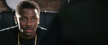 Movie still from “Notorious” (2009), directed by George Tillman Jr. – A person wearing a black jacket; Close Up shot, Over the shoulder angle