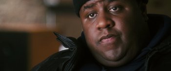 Movie still from “Notorious” (2009), directed by George Tillman Jr. – A person wearing a jacket and a hat; Close Up shot, Over the shoulder angle