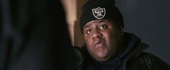 Movie still from “Notorious” (2009), directed by George Tillman Jr. – A person wearing a hat; Close Up shot, Over the shoulder angle