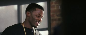 Movie still from “Notorious” (2009), directed by George Tillman Jr. – A person wearing a black shirt; Close Up shot, Over the shoulder angle