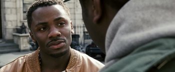 Movie still from “Notorious” (2009), directed by George Tillman Jr. – Two men talking to each other on the street; Close Up shot, Over the shoulder angle