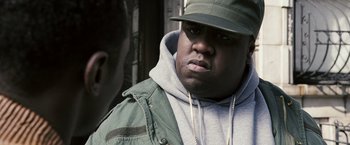 Movie still from “Notorious” (2009), directed by George Tillman Jr. – A person wearing a hat and a jacket; Close Up shot, Over the shoulder angle