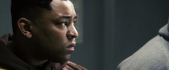 Movie still from “Notorious” (2009), directed by George Tillman Jr. – A person looking at a camera; Close Up shot, Over the shoulder angle