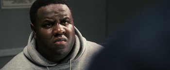 Movie still from “Notorious” (2009), directed by George Tillman Jr. – A person wearing a hooded sweatshirt; Close Up shot, Over the shoulder angle