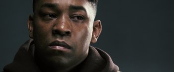 Movie still from “Notorious” (2009), directed by George Tillman Jr. – A person's face with a dark background; Extreme Close Up shot, Low angle