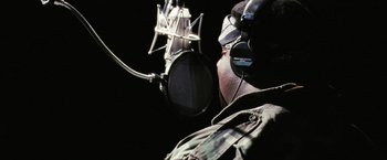 Movie still from “Notorious” (2009), directed by George Tillman Jr. – A man with headphones and a microphone in front of him; Close Up shot, Low angle