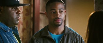 Movie still from “Notorious” (2009), directed by George Tillman Jr. – A person wearing a jacket and a blue shirt; Close Up shot, Over the shoulder angle