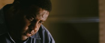 Movie still from “Notorious” (2009), directed by George Tillman Jr. – A person looking down at his face; Close Up shot, Low angle