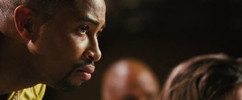 Movie still from “Notorious” (2009), directed by George Tillman Jr. – A man's face in a dark room; Extreme Close Up shot, Over the shoulder angle