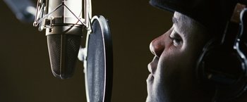 Movie still from “Notorious” (2009), directed by George Tillman Jr. – A man's face as he is recording a song; Extreme Close Up shot, Low angle