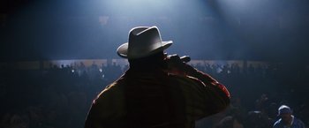 Movie still from “Notorious” (2009), directed by George Tillman Jr. – A man in a white hat is on a stage; Close Up shot, Low angle