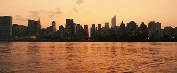 Movie still from “Notorious” (2009), directed by George Tillman Jr. – A view of a city skyline at sunset from across a body of water; Extreme Wide shot, High angle