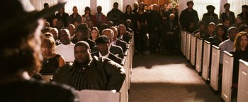 Movie still from “Notorious” (2009), directed by George Tillman Jr. – A group of people sitting in pews in a church; Wide shot, High angle