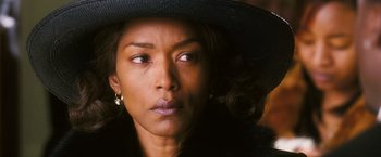 Movie still from “Notorious” (2009), directed by George Tillman Jr. – A person wearing a hat; Close Up shot, Over the shoulder angle