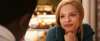 Movie still from “Notorious” (2009), directed by George Tillman Jr. – A person sitting at a table; Close Up shot, Over the shoulder angle