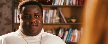Movie still from “Notorious” (2009), directed by George Tillman Jr. – A person in a room with a book shelf in the background; Close Up shot, Low angle