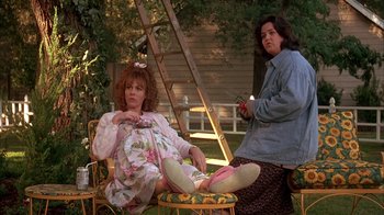 Movie still from “Now and Then” (1995), directed by Lesli Linka Glatter – Two women sitting on a lawn chair in a yard; Medium shot, Low angle