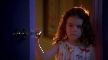 Movie still from “Now and Then” (1995), directed by Lesli Linka Glatter – A little girl holding on to a door knob; Close Up shot, High angle