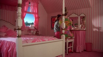 Movie still from “Now and Then” (1995), directed by Lesli Linka Glatter – A woman is standing in front of a mirror in a bedroom; Wide shot, High angle