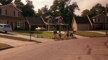 Movie still from “Now and Then” (1995), directed by Lesli Linka Glatter – A group of people standing on the side of a road; Extreme Wide shot, High angle