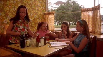 Movie still from “Now and Then” (1995), directed by Lesli Linka Glatter – A group of young girls sitting at a table; Medium shot, Low angle