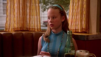 Movie still from “Now and Then” (1995), directed by Lesli Linka Glatter – A young girl sitting at a table in a restaurant; Close Up shot, High angle
