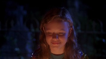 Movie still from “Now and Then” (1995), directed by Lesli Linka Glatter – A young girl with long hair is smiling; Close Up shot, Over the shoulder angle