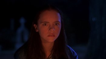 Movie still from “Now and Then” (1995), directed by Lesli Linka Glatter – A woman with long dark hair stares into the camera; Close Up shot, High angle