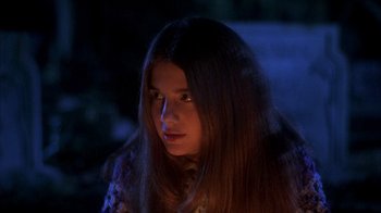 Movie still from “Now and Then” (1995), directed by Lesli Linka Glatter – A young woman with long brown hair stares at the camera; Close Up shot, High angle
