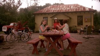 Movie still from “Now and Then” (1995), directed by Lesli Linka Glatter – Three young girls sitting at a picnic table drinking soda; Wide shot, High angle