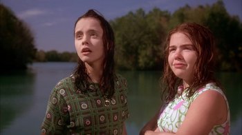 Movie still from “Now and Then” (1995), directed by Lesli Linka Glatter – Two young women standing next to each other near a body of water; Close Up shot, Low angle