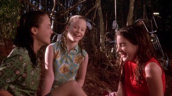 Movie still from “Now and Then” (1995), directed by Lesli Linka Glatter – Three young girls sitting in the woods laughing; Medium shot, High angle
