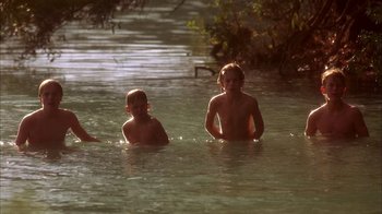 Movie still from “Now and Then” (1995), directed by Lesli Linka Glatter – A group of children swimming in a body of water; Wide shot, High angle
